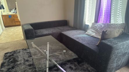 L shaped sofa and glass table