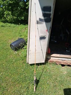 Vintage two piece fiberglass rod with a Mitchell 1040 fishing reel