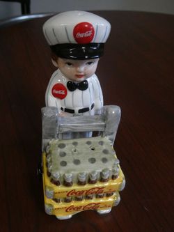 Vintage 2 Coca Cola Items 1 Porcelain Delivery Man W/Cart And 1 Gas Pump Style Both Salt And Pepper Shakers Like New Located In Palm Springs CA 
