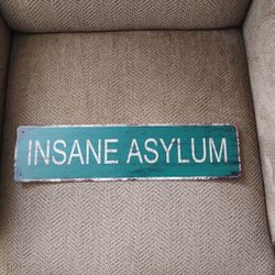 ASYLUM METAL SIGN.  4" X 16".  NEW.  PICKUP ONLY