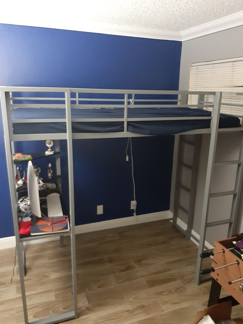 Kids bunk bed with an additional computer desk at the bottom