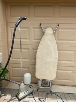 Old clothing steamer and ironing board