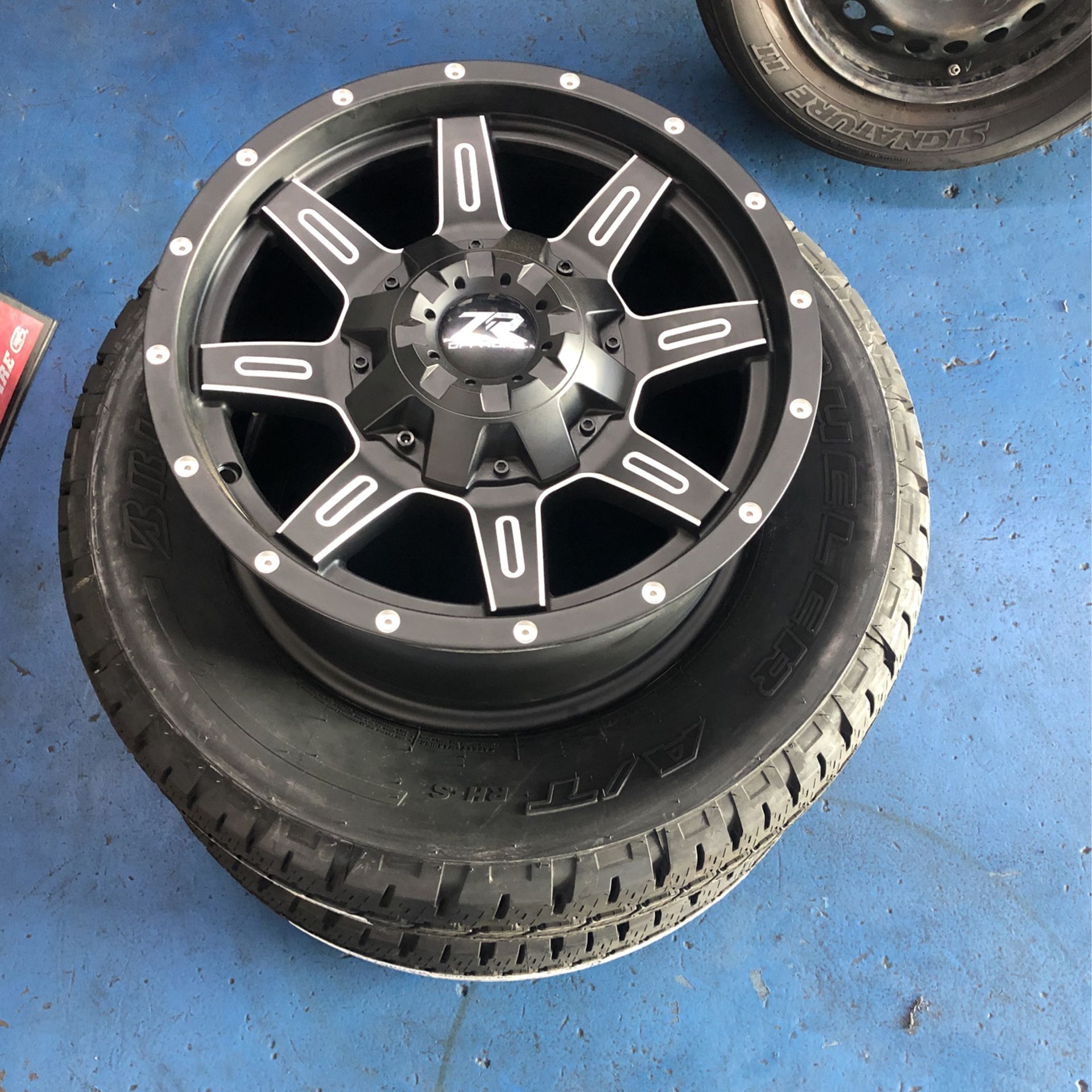 New set of ZR 17x8.5 Rims with two bridgestone tires 255/65-17