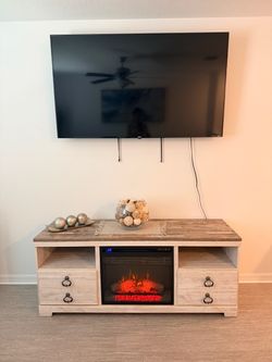 e Ashley Furniture Willowton TV Stand with an included electric fireplace., tv