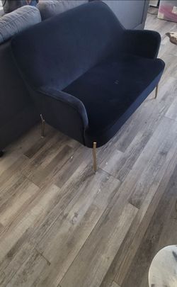 Black velvet couch with gold legs