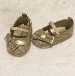 Gold baby shoes