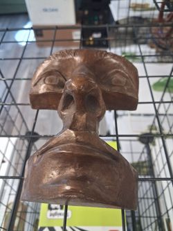 Solid bronze face sculpture signed.