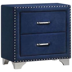 Velvet upholstered bed with a high backrest in blue and two nightstands and a dresser. A spectacular bed
