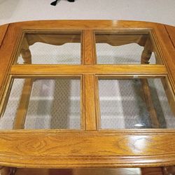 Wooden Table With Beveled Glass Panels And Extenders On Each Side