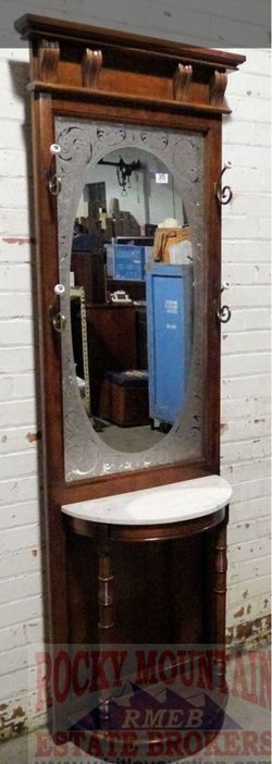Pulaski vintage style hall tree with fancy decorated mirror. 79" high.