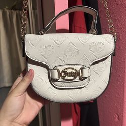 white Juicy Couture heart-embossed mini crossbody bag
