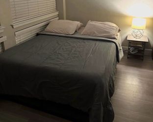 Queen bed with box springs and base.