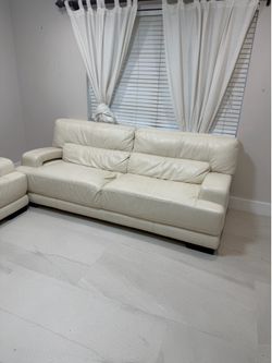 Two genuine off white leather sofas