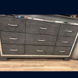 Grey wooden dresser with mirror accents 