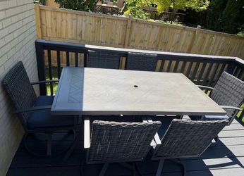 Outdoor table and six swivel chairs