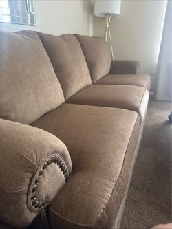 Tan, nailhead sofa and loveseat