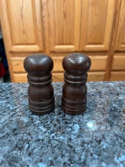 Vintage Wood Pair of Salt and Pepper Shakers.   Size approximately 3 inches tall.  Has been on display in a cabinet with very large salt and pepper sh