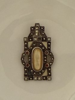vintage Art Deco style brooch crafted from sterling silver, marcasite, and mother-of-pearl
