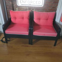 2 red cushions wicker chairs