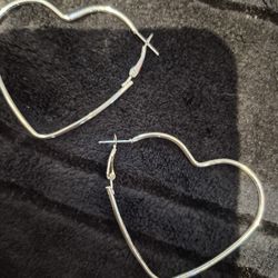 Costume jewelry, heart shape earrings pierced.