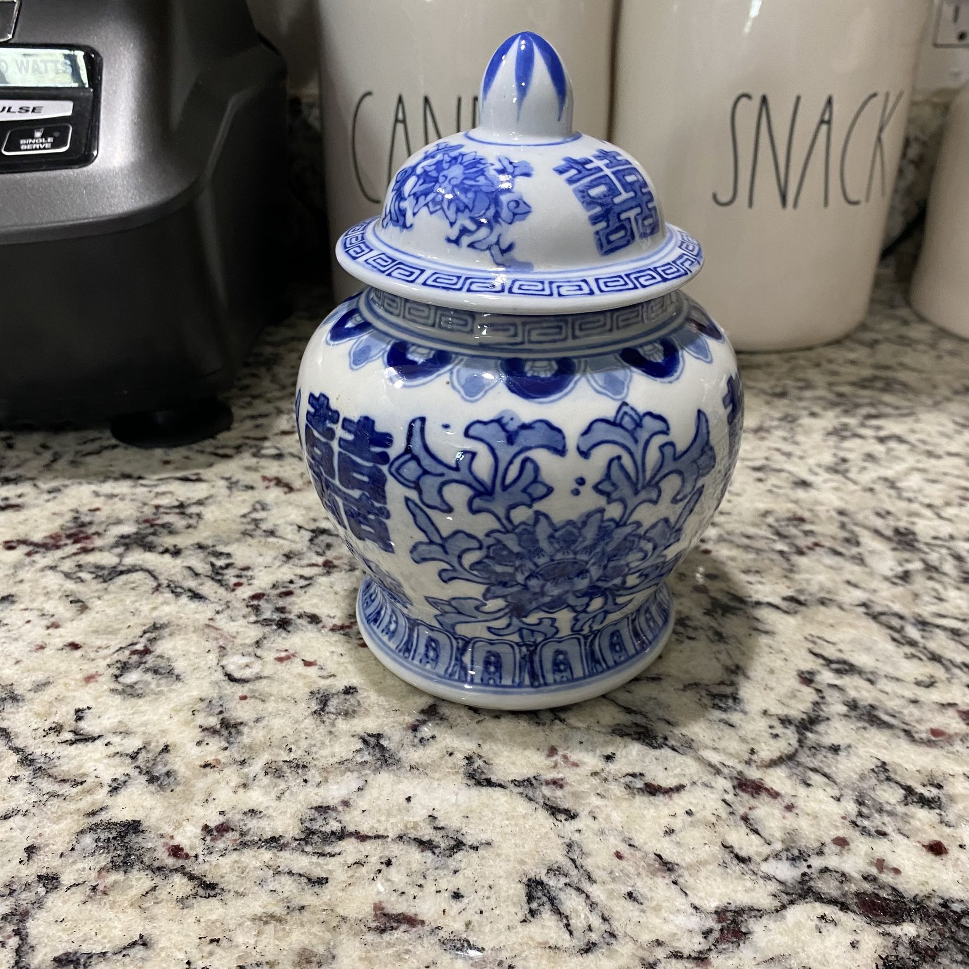 Chinese covered vase Blue and White Porcelain Lidded Urn, which is used for decorative purposes or for storing items like tea or spices