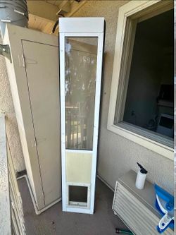 Electronic sliding glass patio pet door insert by High Tech Pet. This white aluminum frame insert has a glass upper section and an automatic motorized