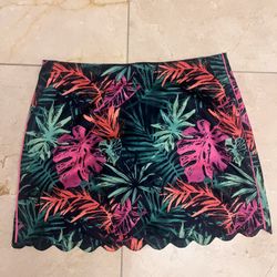 The Lady Hagen Skort in women's size 14 features a vibrant pink tropical palm floral pattern, making it perfect for golf or tennis activities. This at
