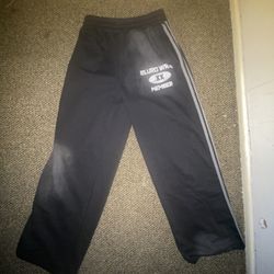 Black Sweatpants With Dark Grey Adidas Stripes Also Is Dark Washed  Baggy.