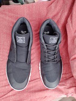 Nike SB Stefan Janoski Max Mid sneakers in black featuring white soles.