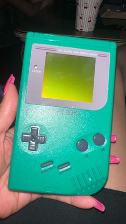 Green nintendo gameboy with one game tetris