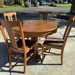 Dinner table with Antique Chairs & Center Leaf. 
