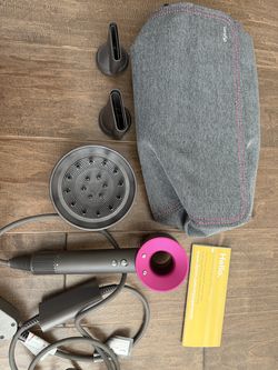 Dyson supersonic hairdryer in fuchsia with 3 attachments and Dyson travel bar