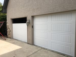 Two Heavy Duty Carriage Court Mahogany Stained Garage Doors With Wooden Overlay And Decorative Handles Garage Doors Prices Garage Doors Garage To Living Space