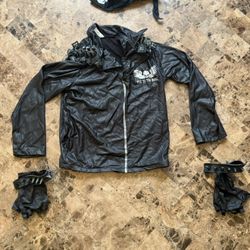 "Bad to the Bone" Halloween costume, featuring a faux leather jacket with silver latex spikes on the shoulders and a skull and wings graphic on the ch