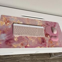 Pink office supplies. Logitech Wireless keyboard, Logitech wirelesss mouse, computer pad, mouse pad