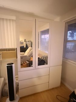 White dresser with hanging rack and mirrors