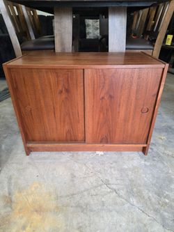 Danish style sliding door cabinet,  kinda like the size of a large end table,  $70
