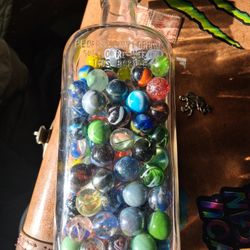 OLD BOTTLE FULL OF MARBLES