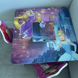 Kids’ activity table with 2 chairs, decorated with Elsa designs.