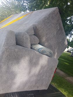Gray sectional with rug and pillows