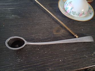 this is a vintage cup-style candle snuffer