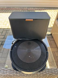 Selling two iRobot vacuum cleaners: one large unit currently in use and one small unit that hasn't been used for a long time.