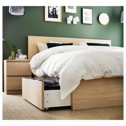 IKEA MALM King bed frame in white stained oak veneer with 4 storage drawers, like new, includes slatted bed base, fits a 76x80 inch mattress.