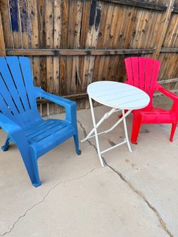 Set of 2 chairs with polypropylene frames and a 2.6 ft round folding table.