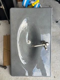 Cast-iron sink, grayish color with Kohler faucet