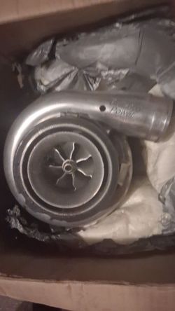 high-performance turbocharger with a polished compressor cover, appearing to be a Bullseye Power S-series