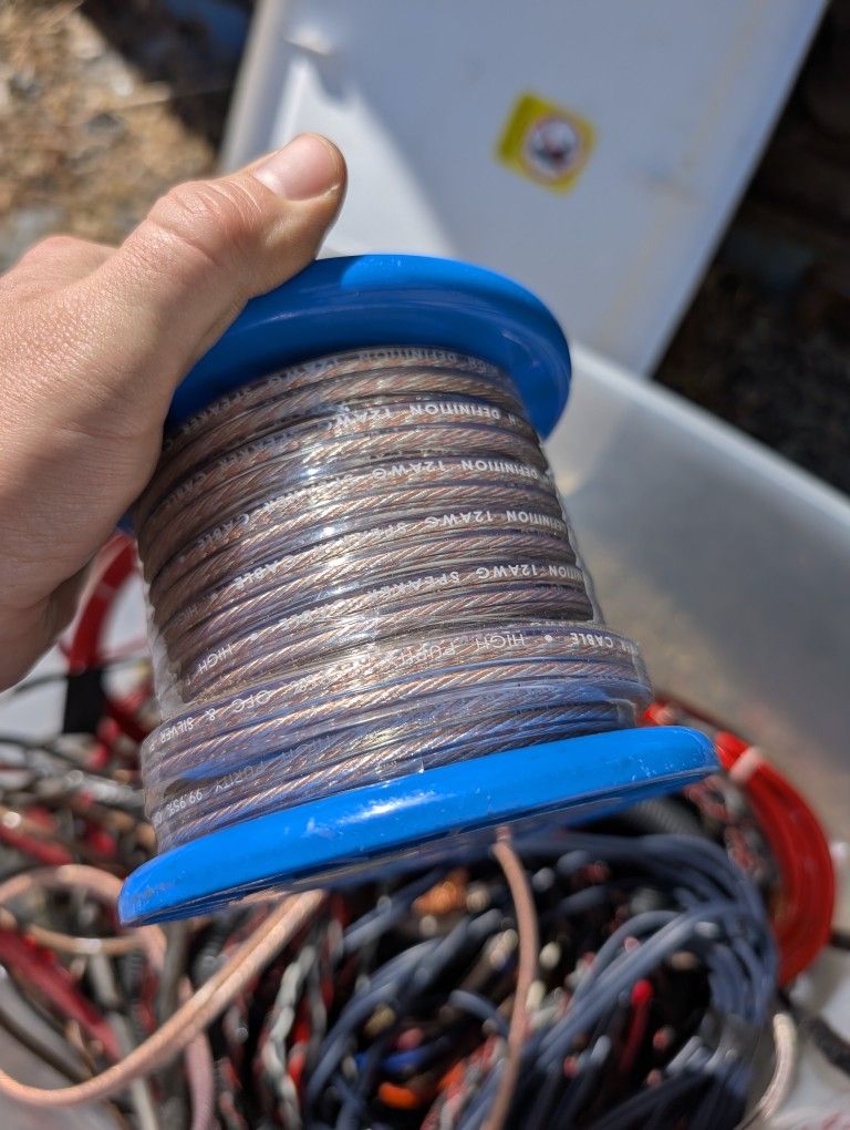 Box full of speaker wire, RCA cable, and amp cables