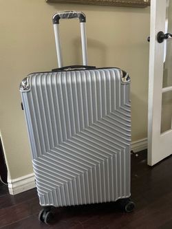 Silver hard shell suitcase with 360 spinning wheels, 50lbs, New