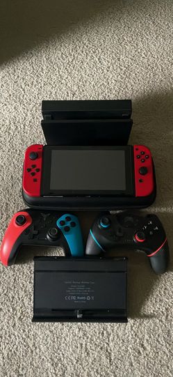 Nintendo Switch 1 with Console, 2 extra controllers, protective case, and extra battery pack