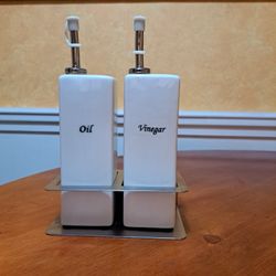 Oil and vinegar set in a stand, 6 in wide By 9 in tall.